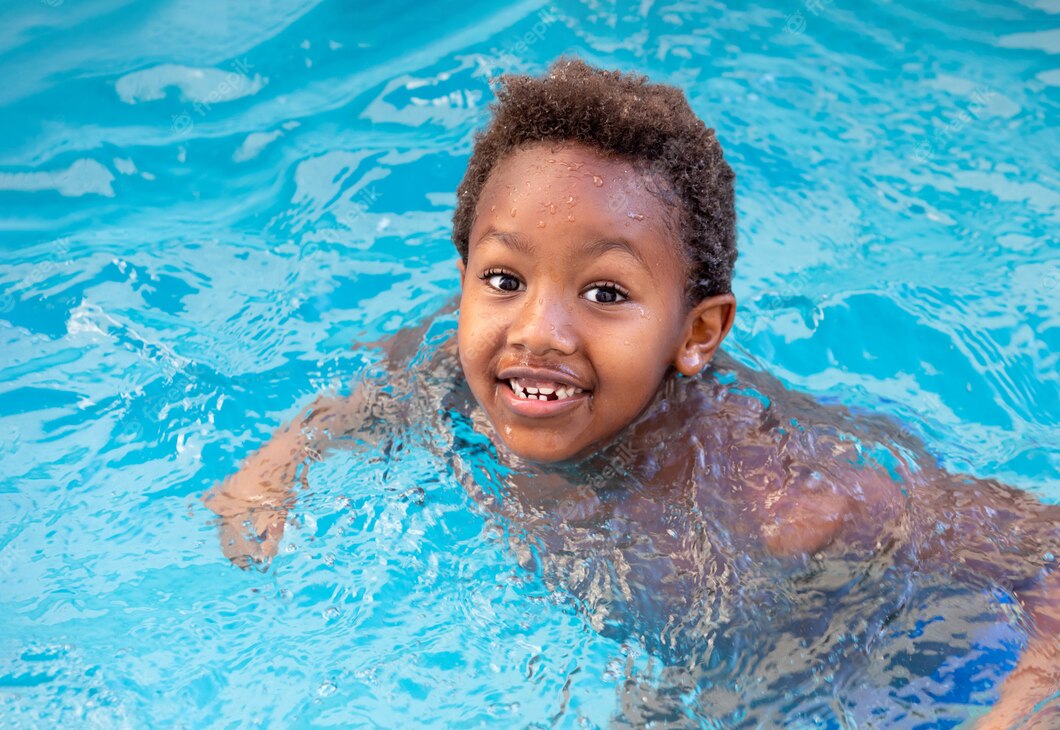 little-african-child-splashing-out-pool_58409-21740